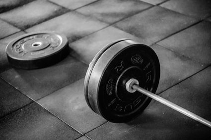 Weightlifing a barbell with plates.