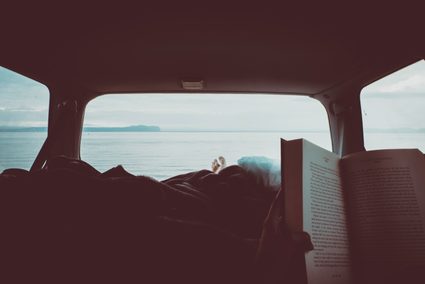 Man reading in a van.