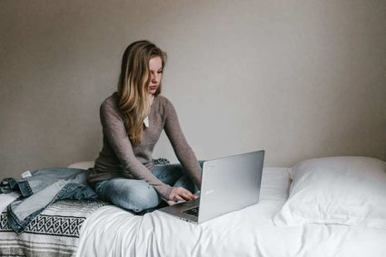 Woman writing at a laptop