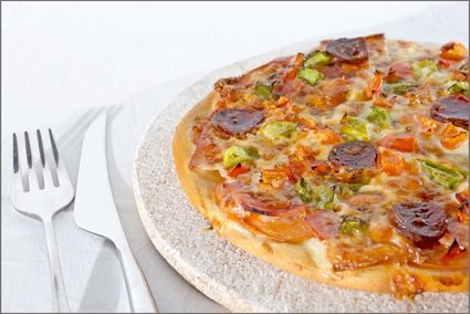 Pizza sobre una placa de piedra refractaria.