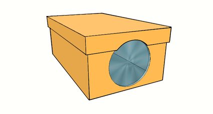Image of the cut shoebox lid to accommodate the area of the lens.