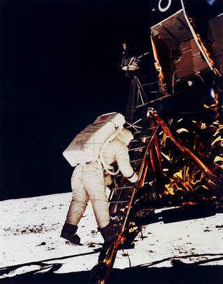 Buzz Aldrin climbs down the Eagle's ladder to the surface.