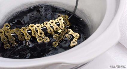 Bicycle chain submerged in melted wax.